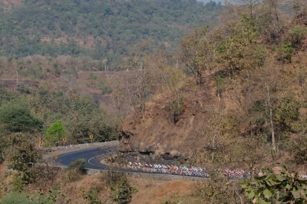 The peloton weave through the India landscape