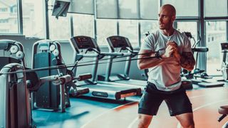 Man performing anti-rotation hold in gym