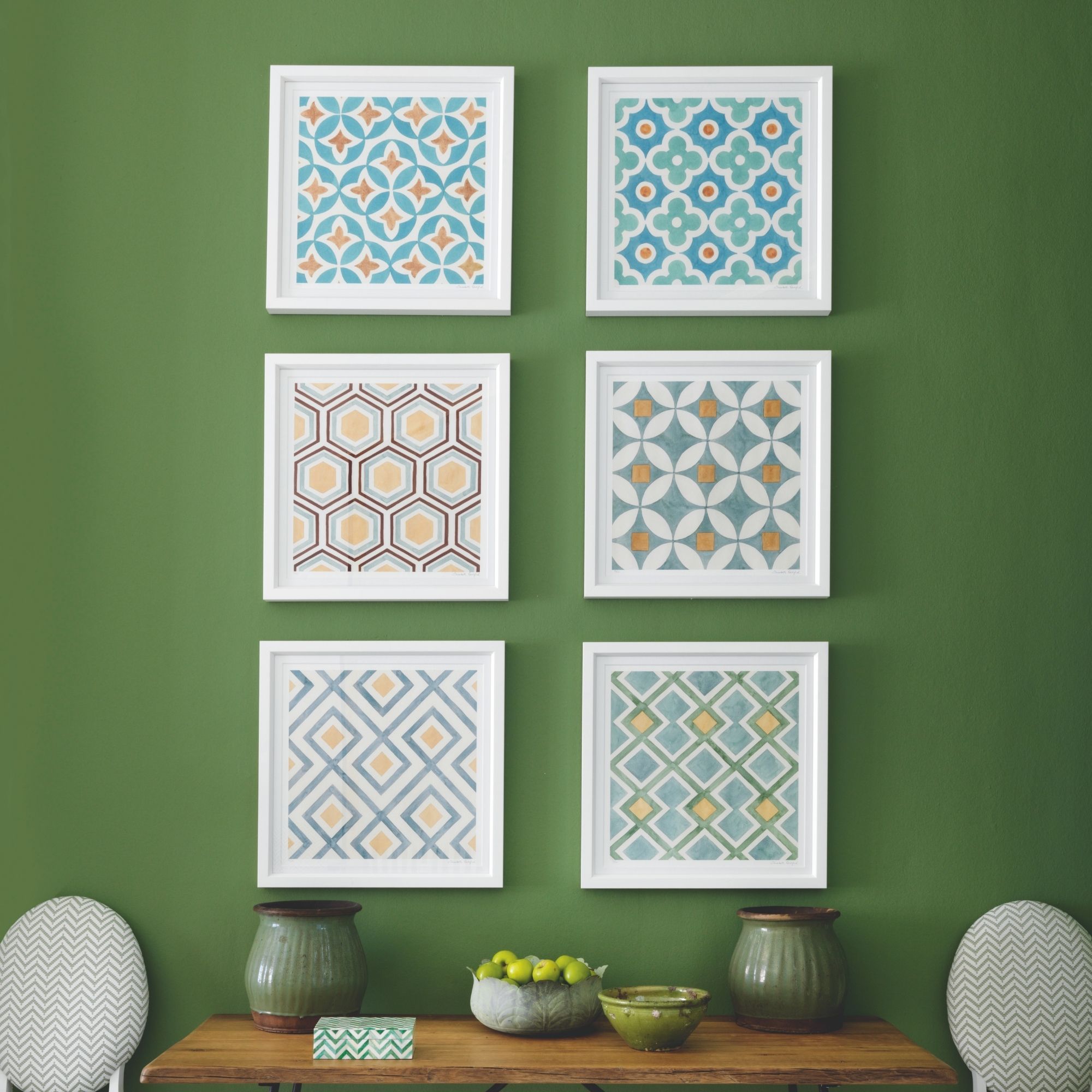 Framed retro wallpaper as wall art on green wall