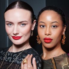 two women with glowing skin and long black lashes