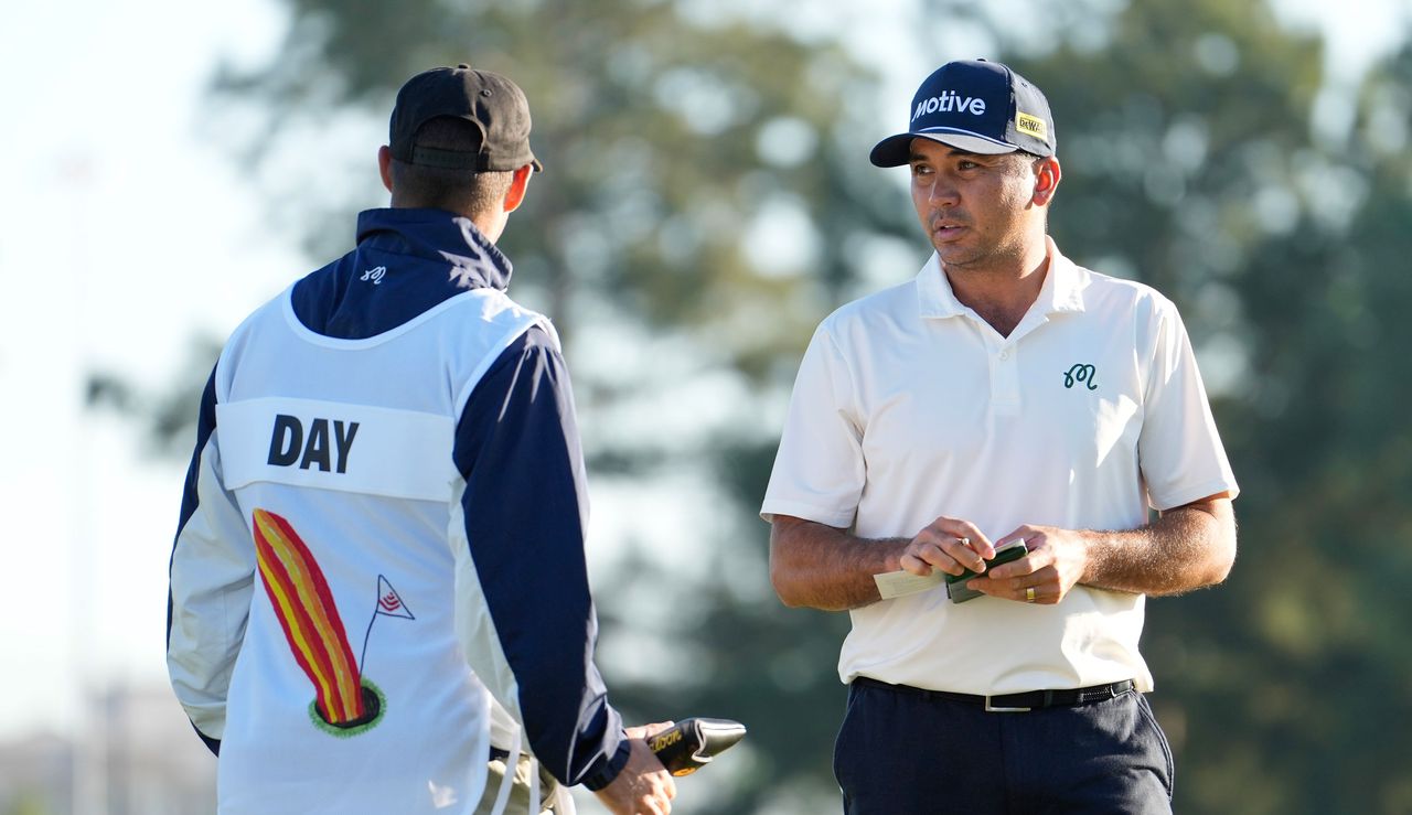 Jason Day talks to his caddie 