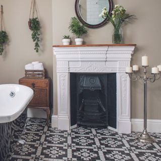 white fireplace with cast-iron interior in bathroom