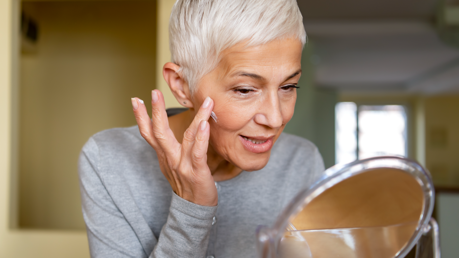 Woman looking at face in mirror