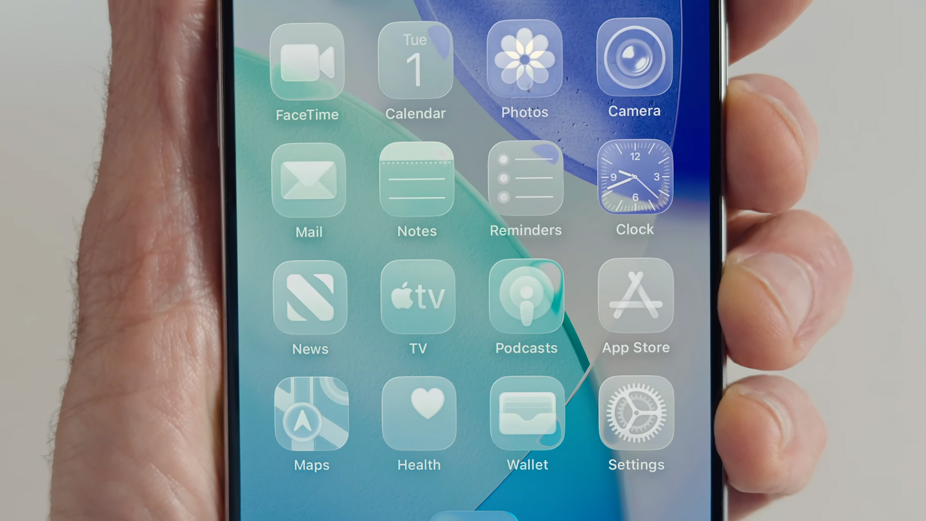 A hand holding an iPhone showing the 'all clear' look on iOS 26