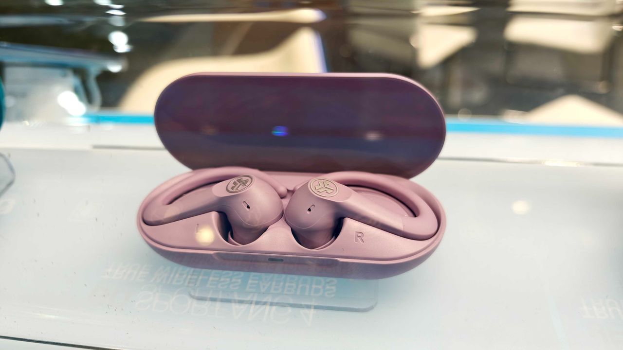 JLab's new earbuds at IFA, on a blue table