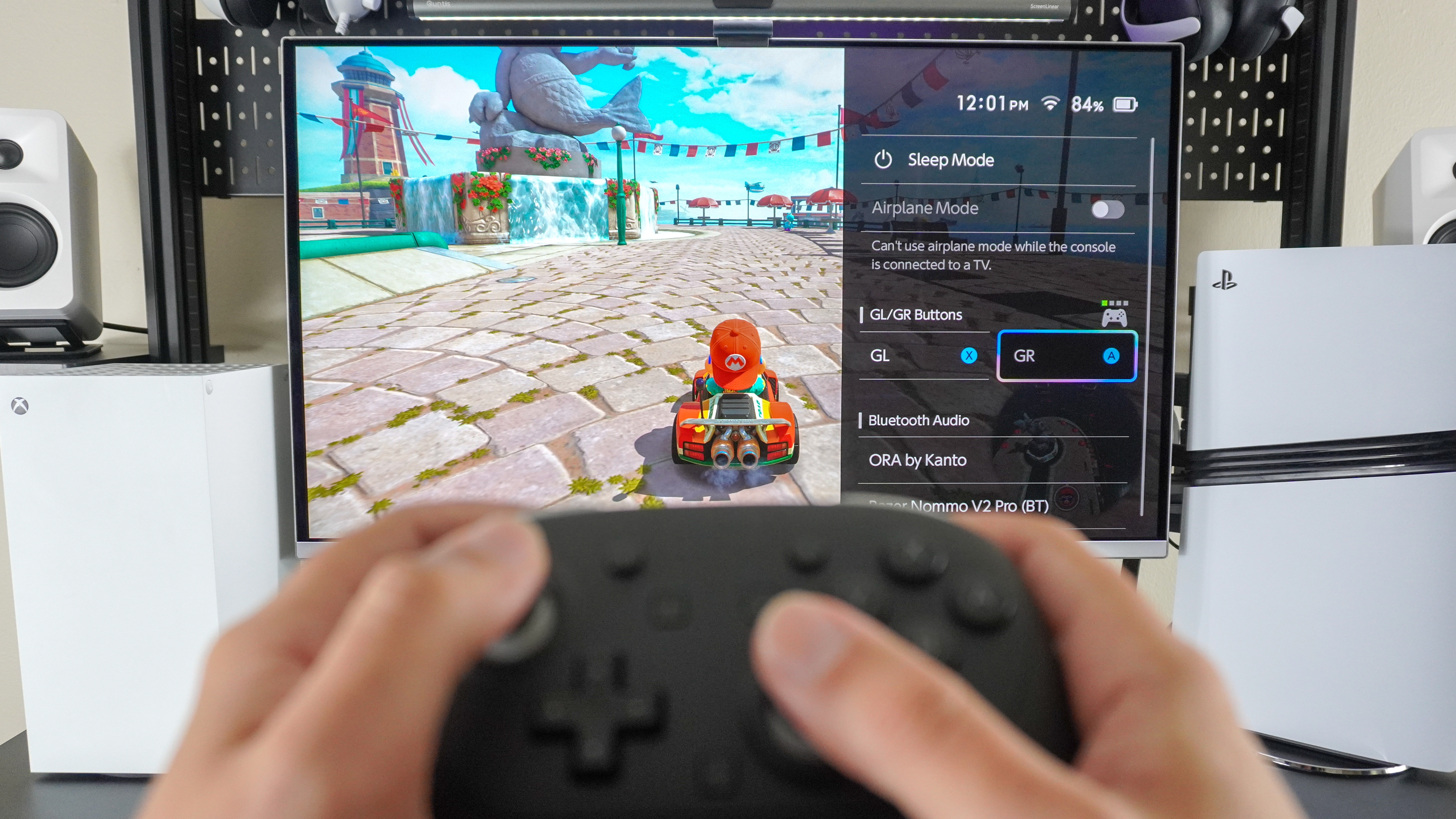 A person playing Mario Kart World with the Nintendo Switch 2 Pro Controller with the Switch 2's Quick Settings menu on screen showing what the GL/GR buttons are mapped to