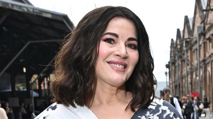 Image of Nigella Lawson smiling with brunette curly shoulder-length bob