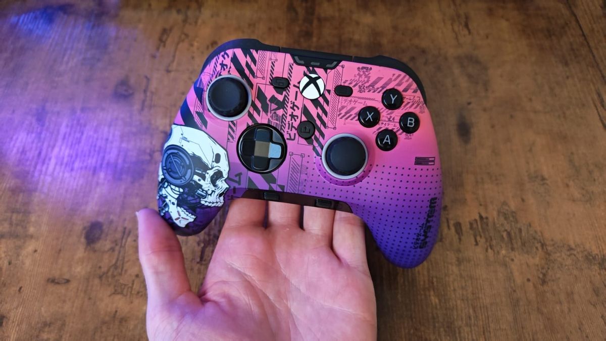 A reviewer holding the Scuf Valor Pro Wireless