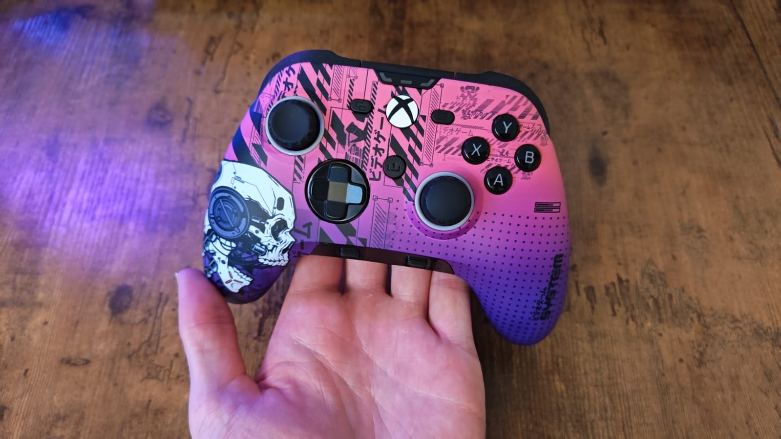 A reviewer holding the Scuf Valor Pro Wireless