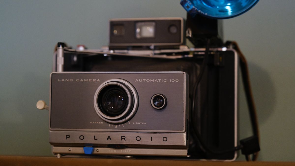 The Polaroid Land Camera Automatic 100 sits on a table