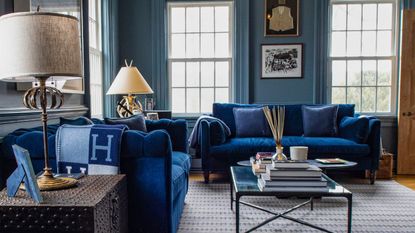 sitting room with blue walls and blue sofa and coffee table