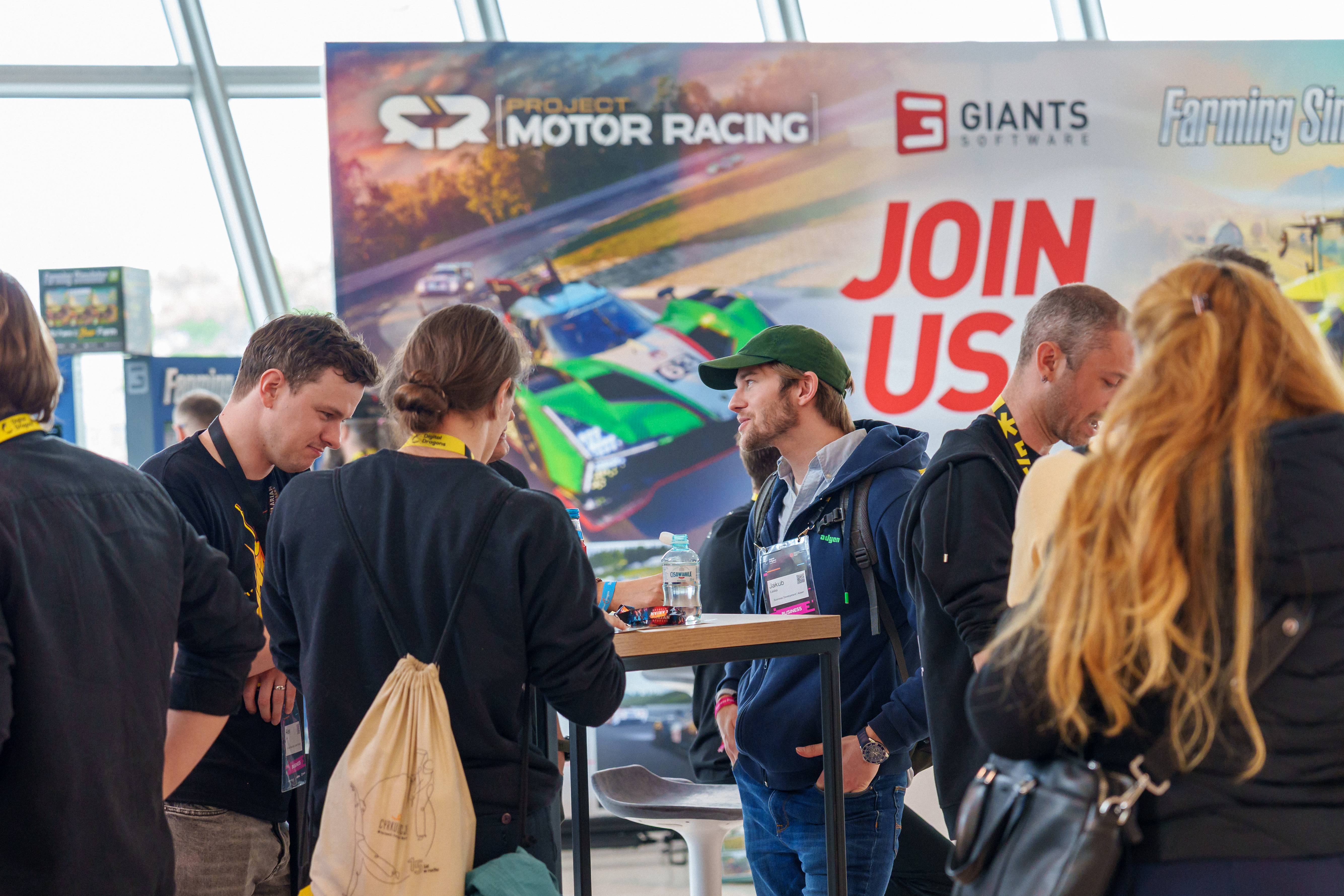Digital Dragons 2025 photograph of people at a gaming convention in Krakow, Poland, gathered around a sponsor booth