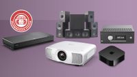 The Panasonic DP-UB820 Blu-ray player, KEF Q Concerto speaker package, Epson EH-LS9000 projector, Apple TV 4K streamer and Arcam AVR5 AV receiver, all arranged against a purple background