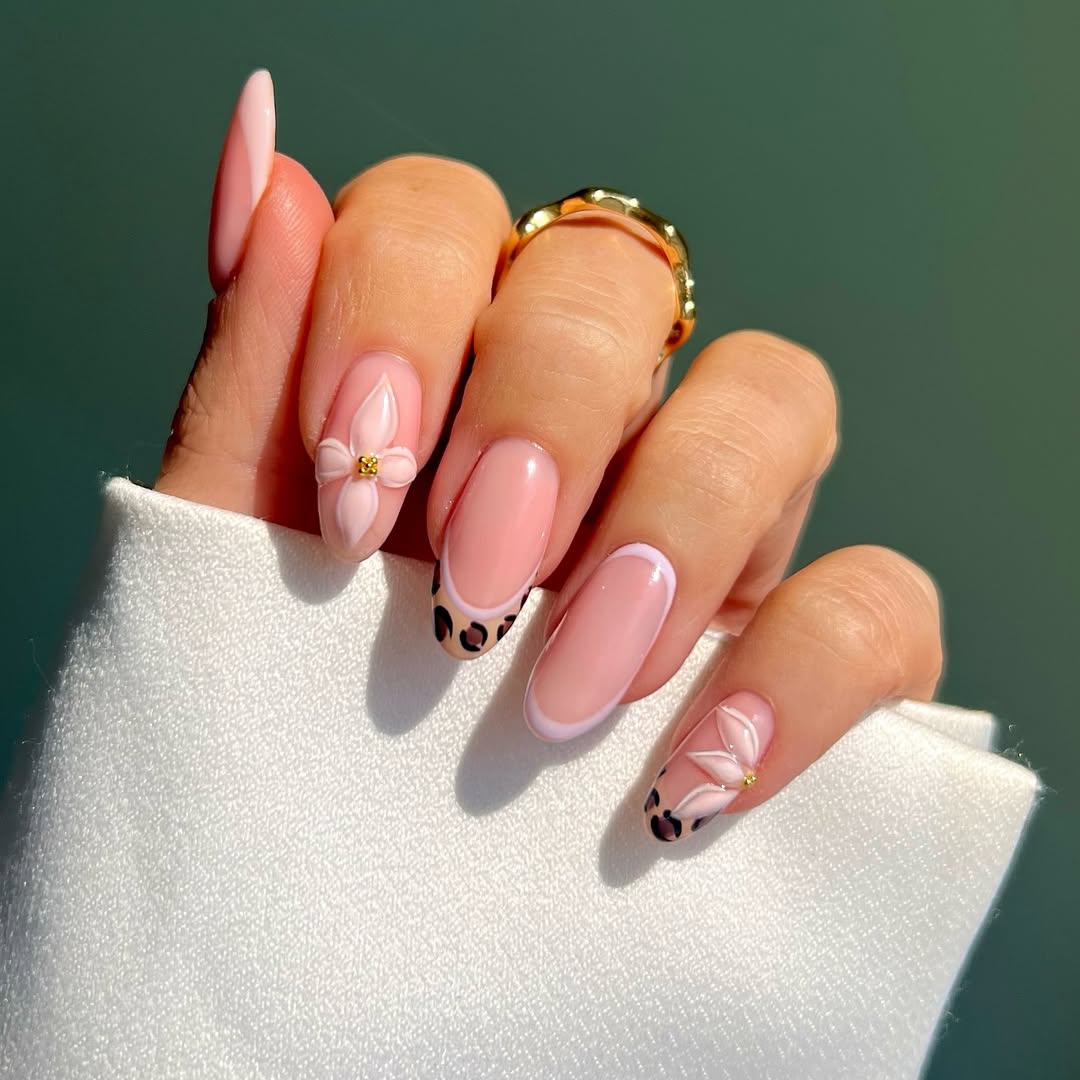 leopard French tip nails with a nude base and white flower details