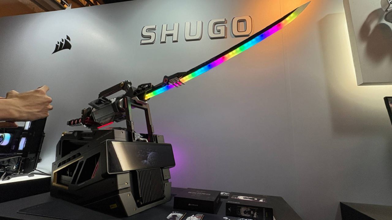 An RGB samurai sword on a pedestal that is actually a PC. The words 'Shugo' can be seen on the wall behind the exhibition piece from Corsair.