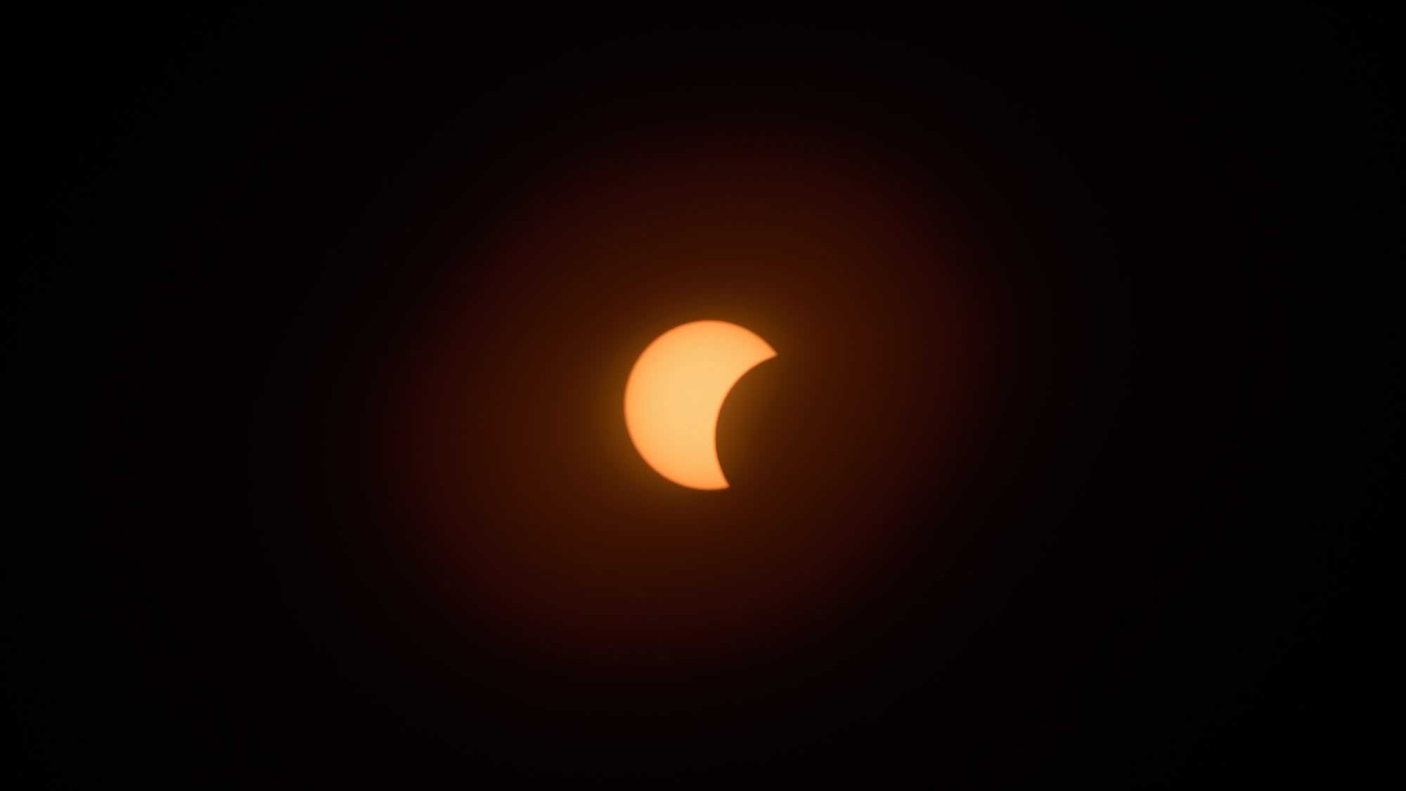 an orange crescent on a black background
