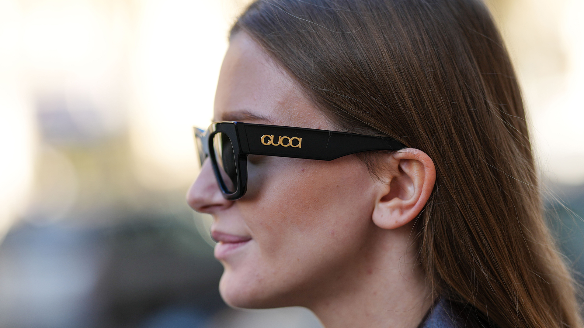 Woman wearing black Gucci sunglasses