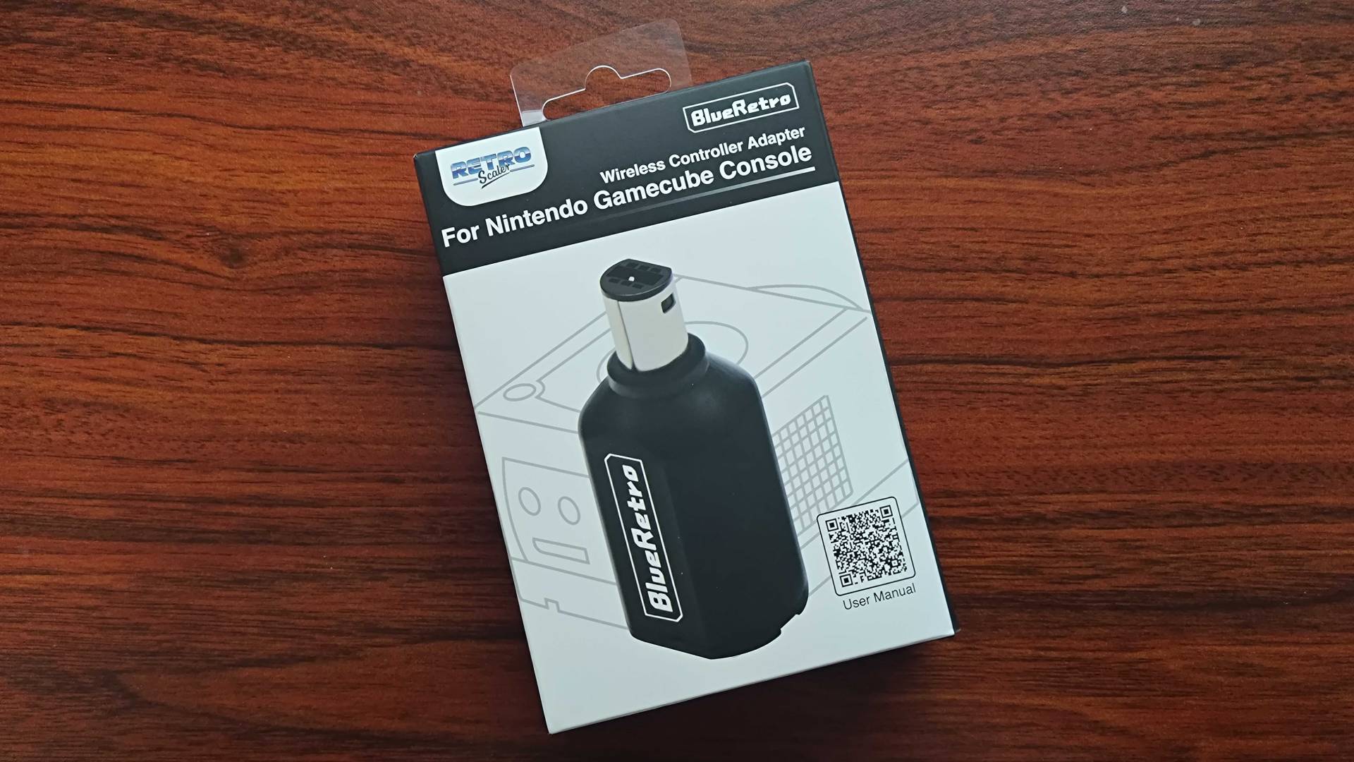 Blueretro GameCube Controller Adapter on woodgrain desk.