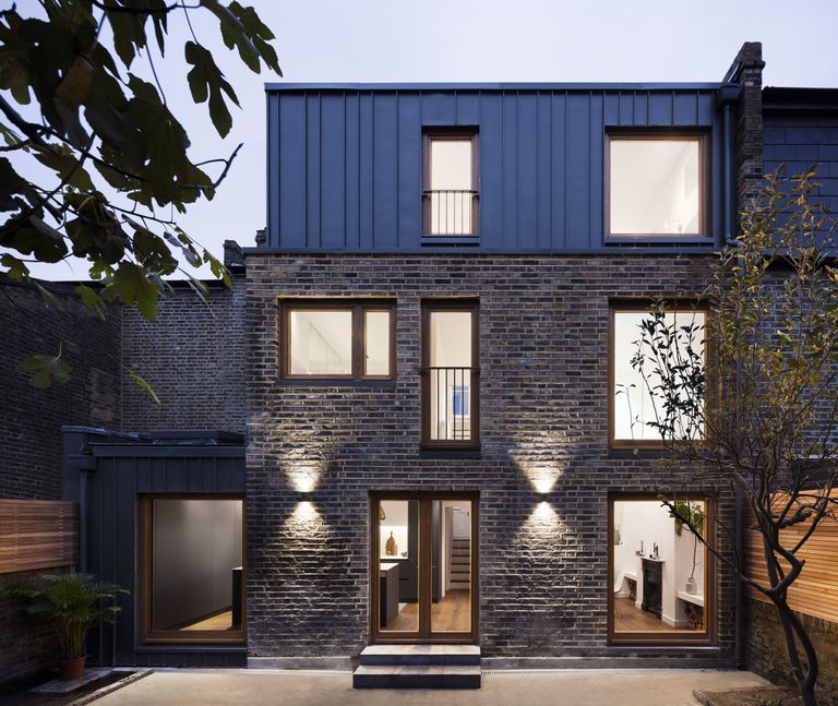 double storey extension with brick and wood panelling and large square modern windows