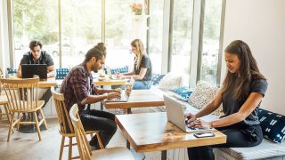 People using laptops in coffee shop