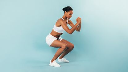Woman showcasing how to do squats