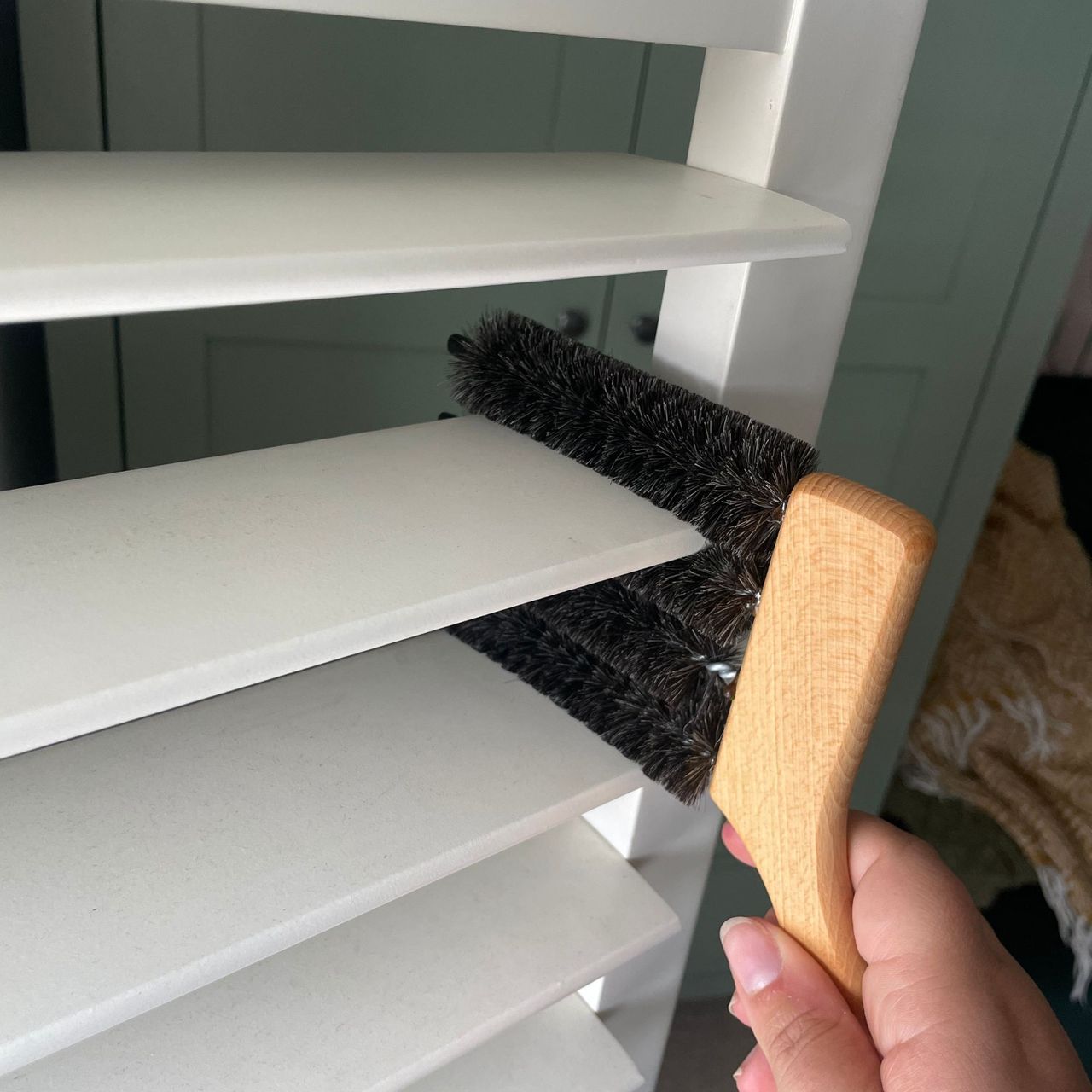 Top prong of the shutter brush cleaning a slat on plantation shutters