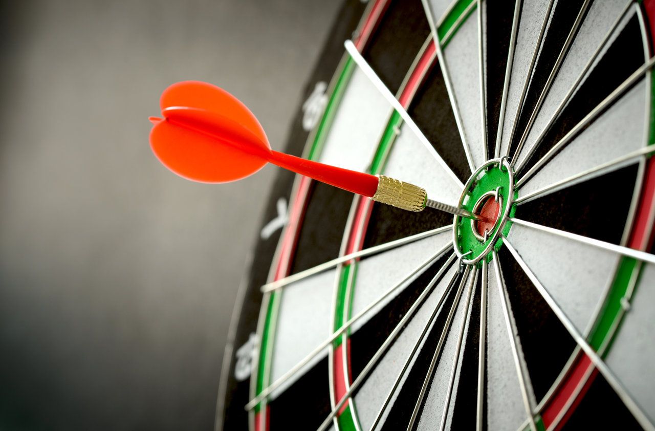 Right on target concept using dart in the bullseye on dartboard