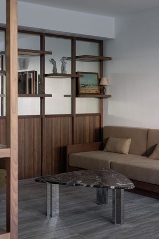 contemporary interior with wooden paneling and a marble coffee table