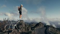 Best bib shorts: Pictured here, a cyclist standing on a rock wearinmg Rapha bib shorts