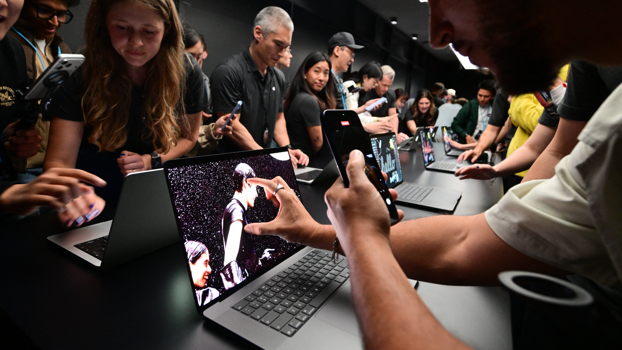 Attendees view the new touchscreen MacBook Pro at the Apple 'Pro and Tell' event on October 28, 2026 in Los Angeles, California