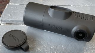 The Vava 2K Dual Dash Cam on a concrete surface