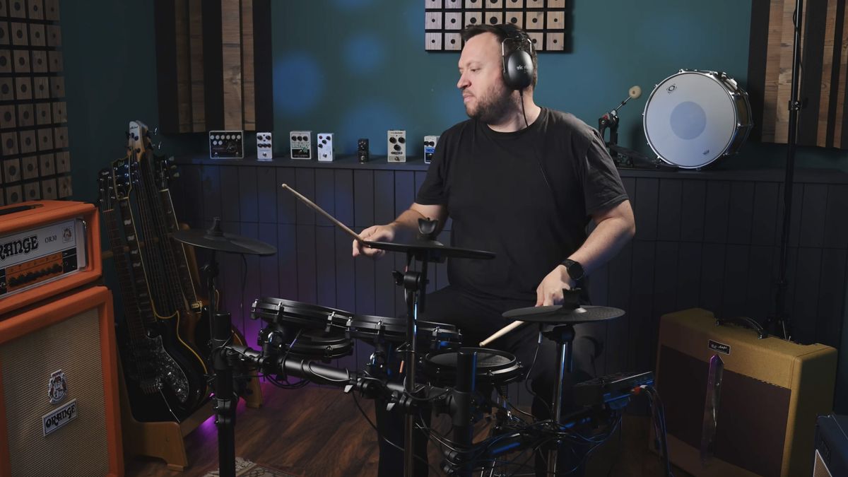 Man playing Alesis Turbo Mesh kit in a studio