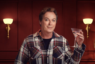 Julian Clary's official Taskmaster portrait where he's holding a martini glass