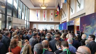 A crowd of attendees waits to enter a conference hall at the 2019 Space Symposium in Colorado Springs, Colorado.