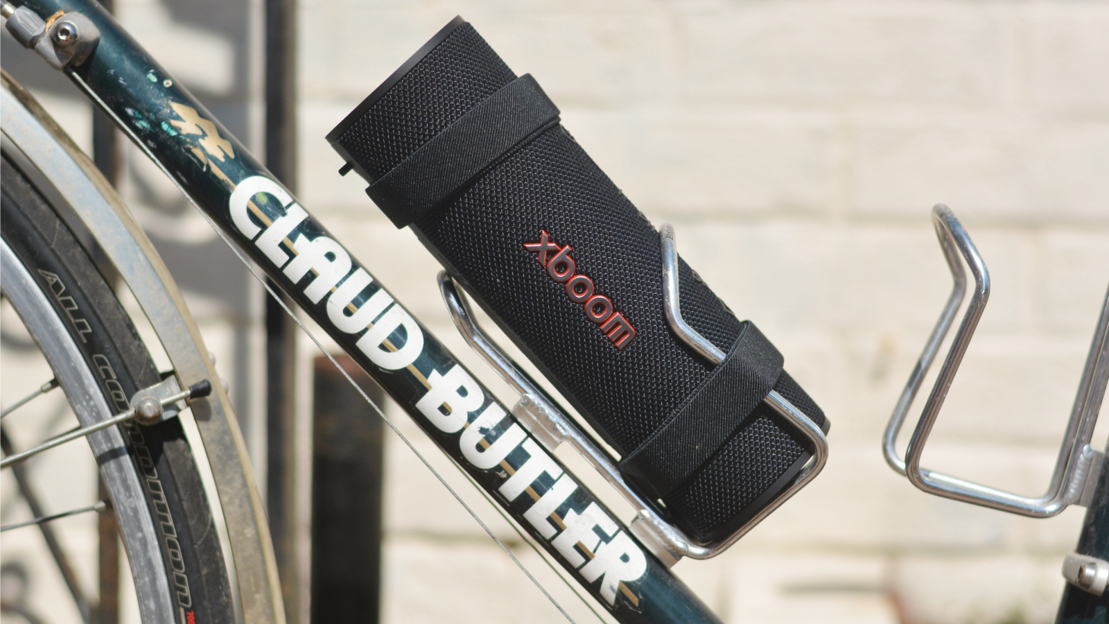 LG xboom Grab Bluetooth speaker in an outdoor setting
