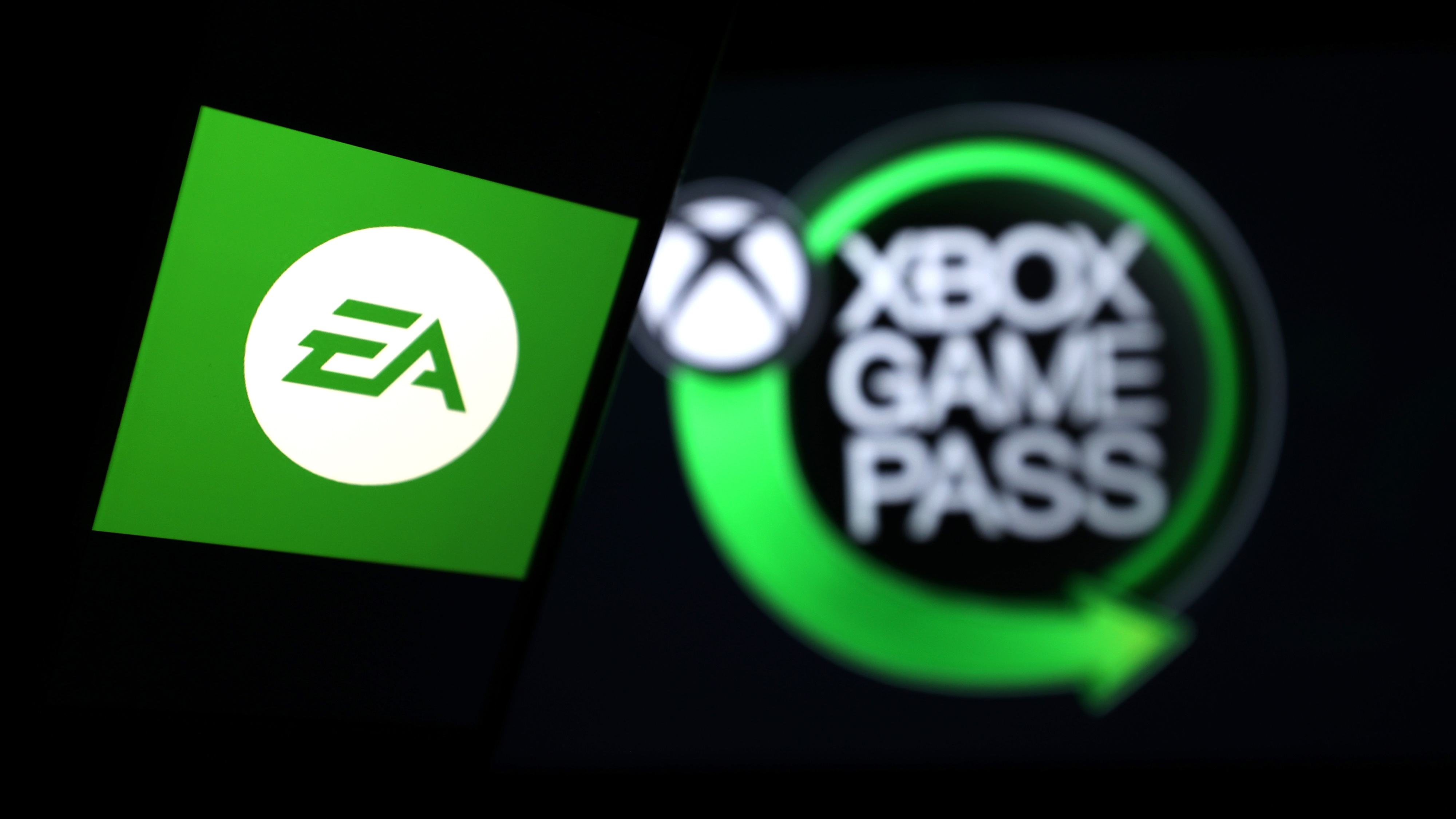  In this photo illustration, a computer screen displays the logo of "Xbox Game Pass" and a smart phone screen displays the logo of "EA Games"