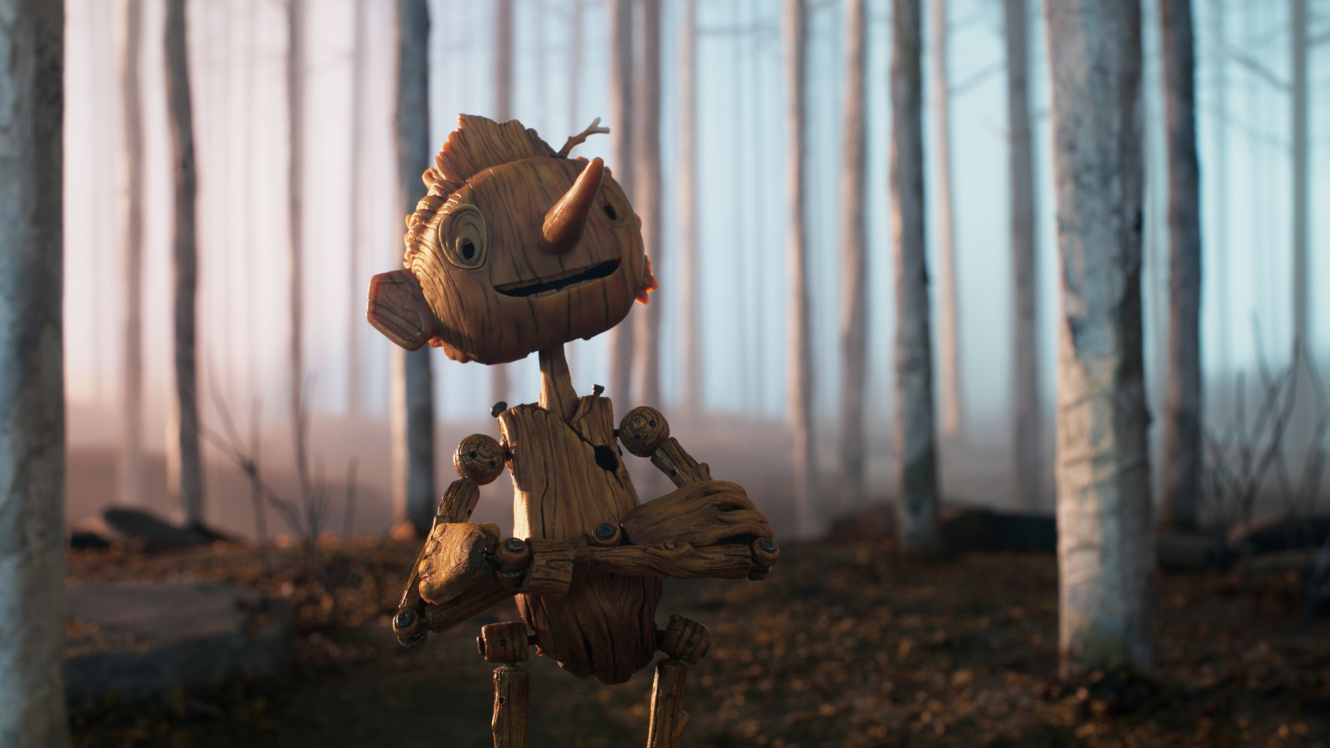 Pinocchio smiles as he crosses his arms in a forest in Guillermo del Toro's stop-motion movie adaptation for Netflix