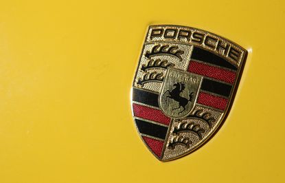 The Porsche logo on a hood ornament