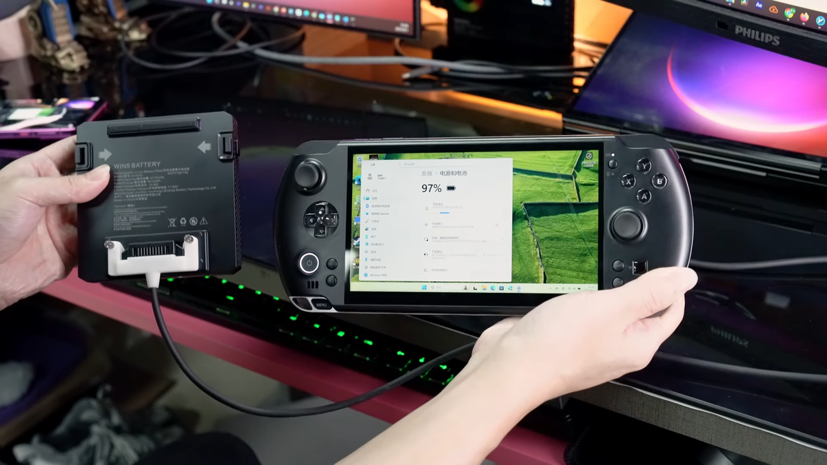 A screenshot of a video from GPD showing off it's new battery optional Strix Halo handheld