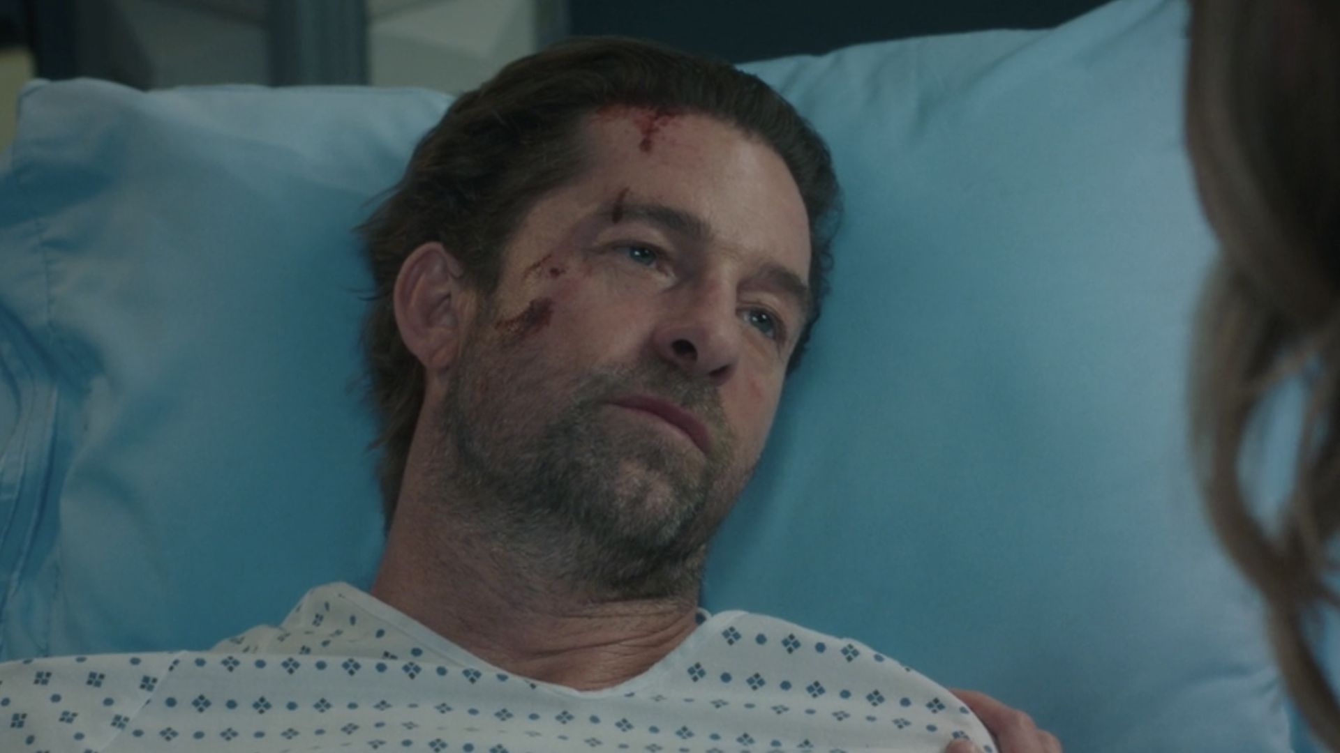 Nick in a hospital gown with minor head wounds in the Season 22 finale.