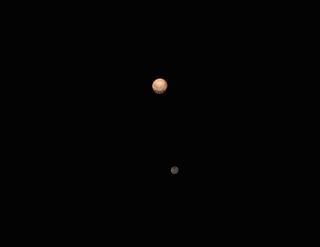 This color view of Pluto and its largest moon, Charon, was captured by NASA's approaching New Horizons spacecraft. The image is a still from a six-frame movie composed of photos New Horizons took between June 23 and June 29, 2015.
