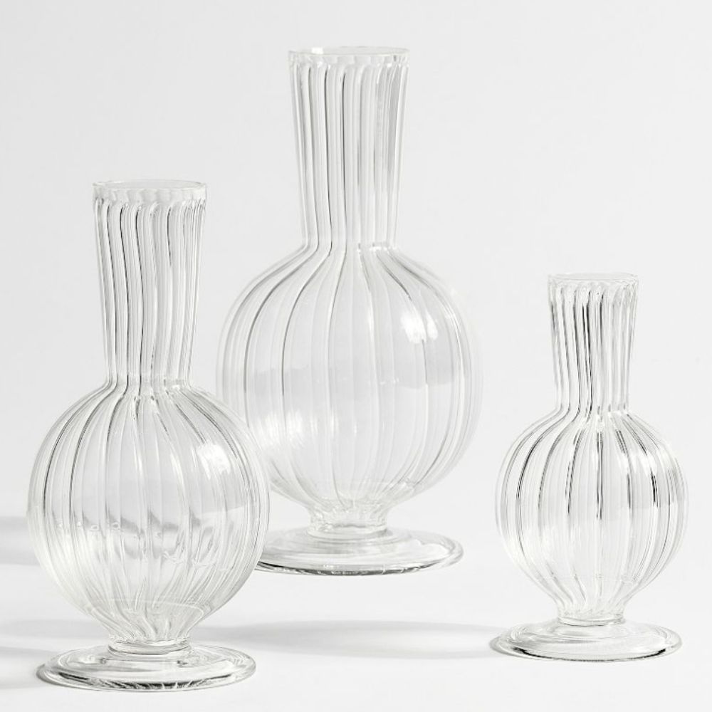 Three glass bud vases on a white background