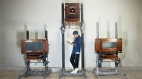 Man with antique large format film cameras