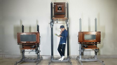 Man with antique large format film cameras