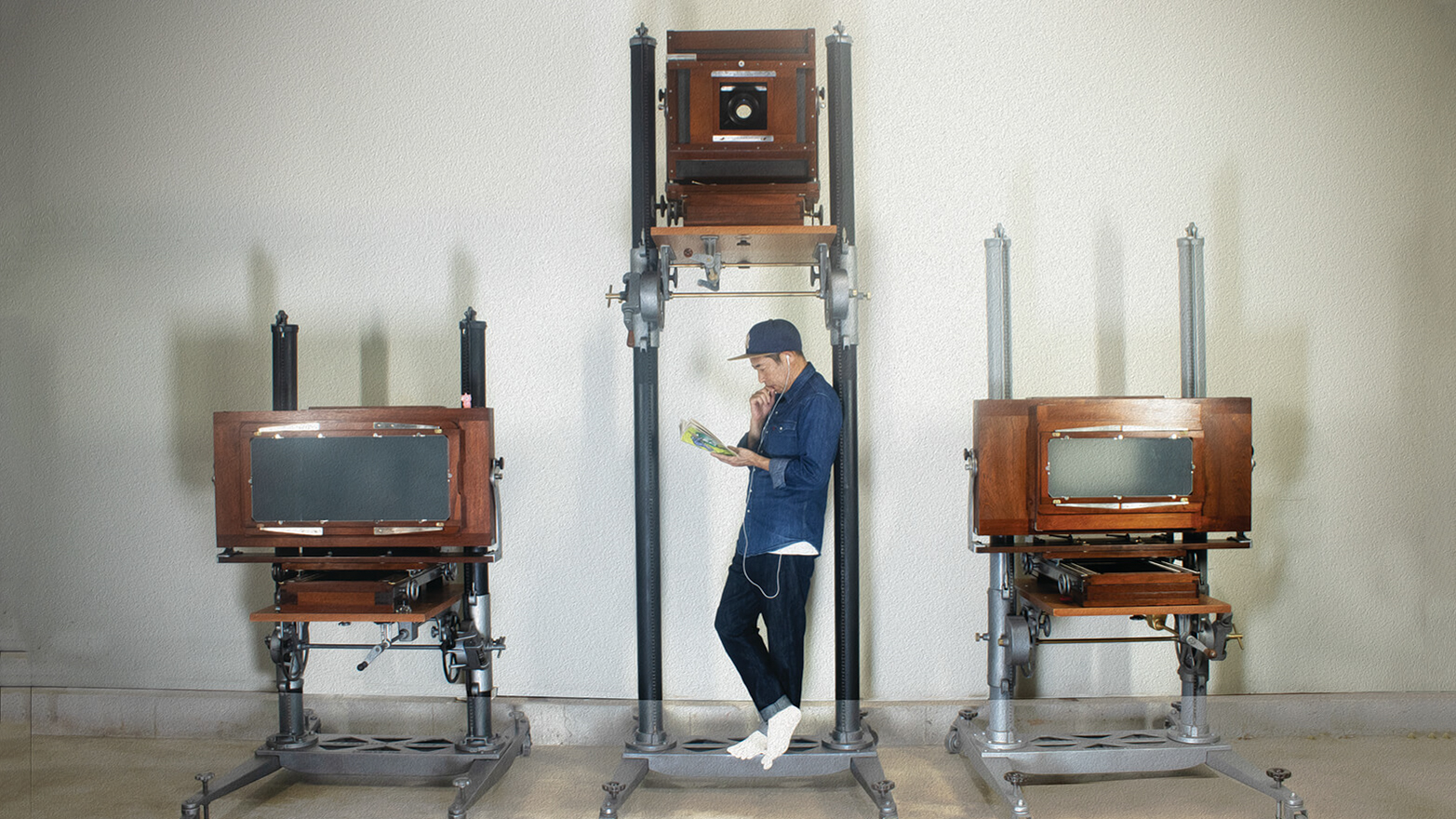 Man with antique large format film cameras