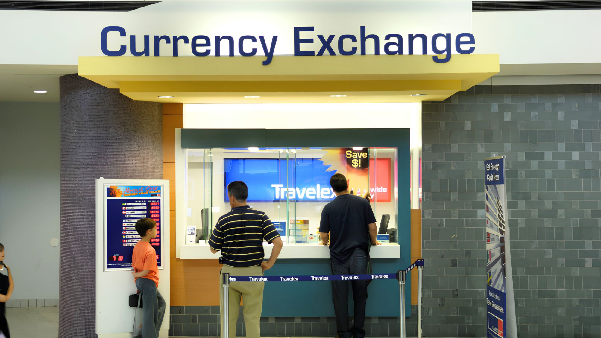 Passengers with bags at the Travelex currency exchange booth