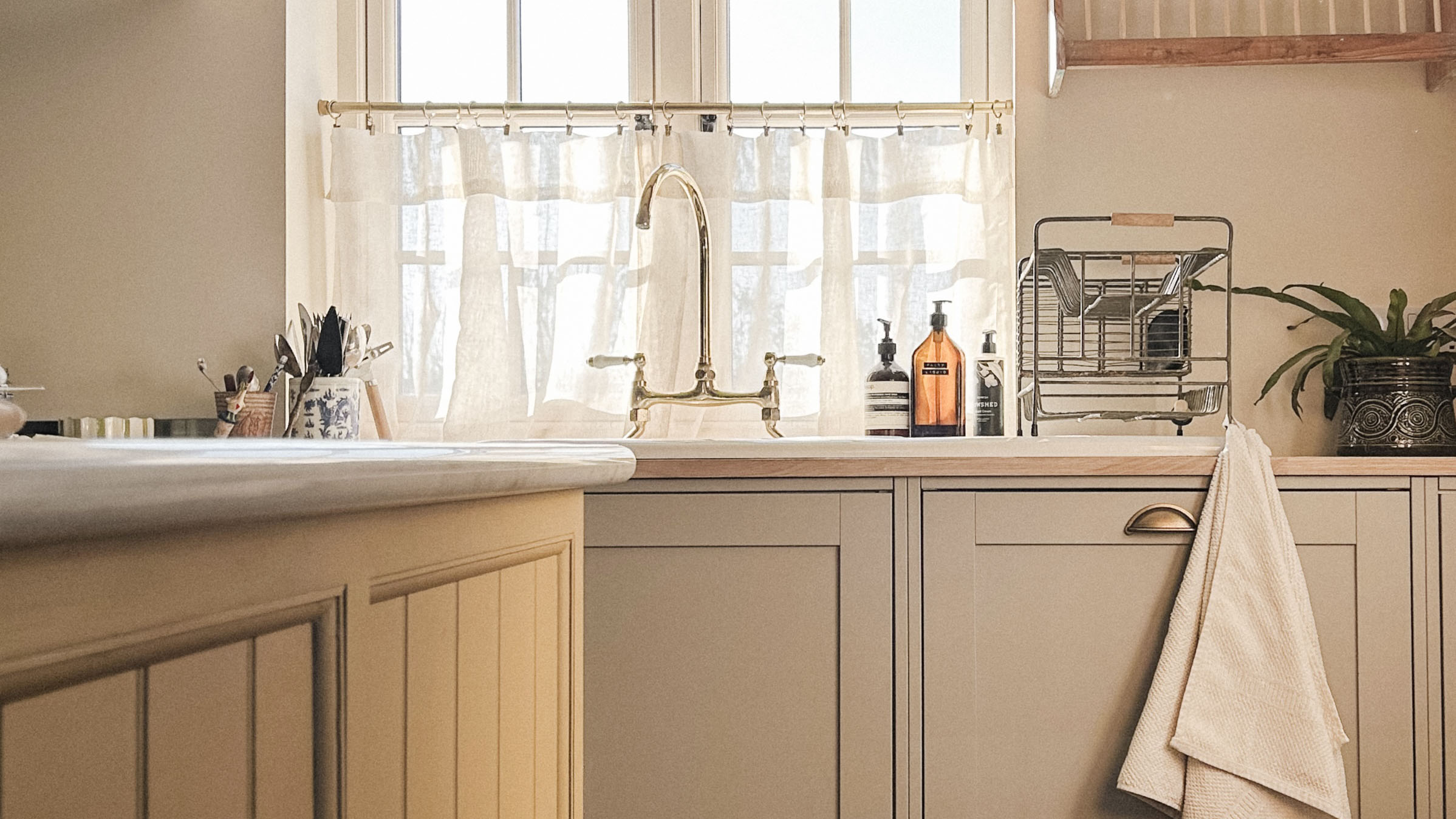 country kitchen with yellow island and grey cabinets