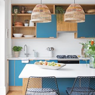 kitchen with blue cabinets and island units with hanging ceiling lights