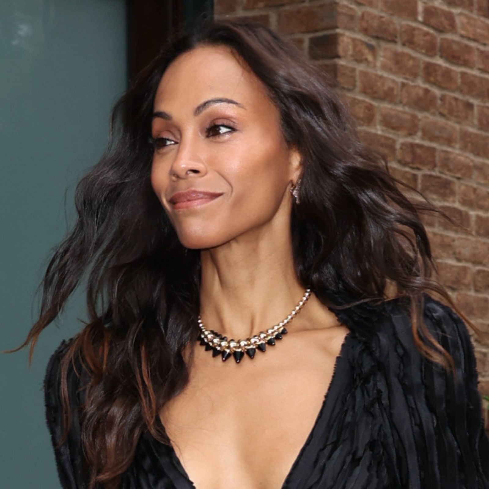 Zoe Saldana is seen on July 29, 2026, in New York City wearing a little black dress with a plunging neckline and high slit.