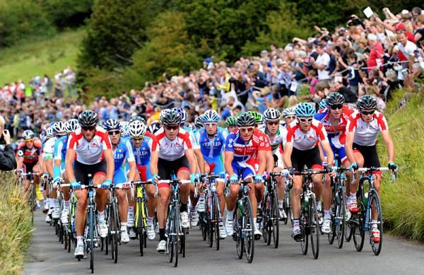 Spectators cheer on the passing peloton.
